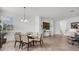 Elegant dining room with glass table and modern light fixture at 14640 Sycamore Ct # 2822, Punta Gorda, FL 33955