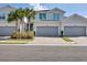 Three-car garage, two-story townhome with gray siding and landscaping at 14640 Sycamore Ct # 2822, Punta Gorda, FL 33955