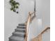 Gray carpeted staircase with wood and white railing at 14640 Sycamore Ct # 2822, Punta Gorda, FL 33955