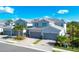 Three attached townhouses with grey exterior and two-car garages at 14640 Sycamore Ct # 2822, Punta Gorda, FL 33955