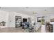 Living room with sectional sofa, built-in shelving, and access to balcony at 14640 Sycamore Ct # 2822, Punta Gorda, FL 33955