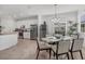 Open concept dining area with seating for six and view of kitchen at 14640 Sycamore Ct # 2822, Punta Gorda, FL 33955