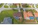 Aerial perspective of two homes, one with a brown roof and the other with an orange roof, each featuring a pool at 2262 Rio De Janeiro Ave, Punta Gorda, FL 33983