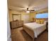 Bedroom featuring a ceiling fan, natural wood furniture, and a window with floral valance at 3767 Tripoli Blvd, Punta Gorda, FL 33950