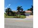 Charming single-story home with well-manicured lawn, mature palm trees, and a driveway at 3767 Tripoli Blvd, Punta Gorda, FL 33950