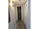 Hallway with light wood-look flooring leads to a bathroom and features a large closet at 4158 Tamiami Trl # C5, Port Charlotte, FL 33952