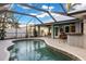 Inviting kidney-shaped pool with screened enclosure at 91 Mark Twain Ln, Rotonda West, FL 33947