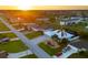 Aerial view of a house and surrounding neighborhood at sunset at 91 Mark Twain Ln, Rotonda West, FL 33947
