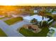 Aerial view of a single-Gathering home with a landscaped yard and driveway at 91 Mark Twain Ln, Rotonda West, FL 33947