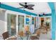 Bright patio with seating area, glass-top table, and access to the pool at 91 Mark Twain Ln, Rotonda West, FL 33947