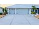 Two-car garage with light gray doors at 91 Mark Twain Ln, Rotonda West, FL 33947