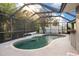 Relaxing kidney-shaped pool with screened enclosure at 91 Mark Twain Ln, Rotonda West, FL 33947