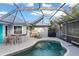 Relaxing pool and patio area with covered lanai and bar at 91 Mark Twain Ln, Rotonda West, FL 33947