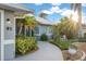 Landscaped walkway leading to the front entrance of a charming house at 91 Mark Twain Ln, Rotonda West, FL 33947