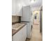 Laundry room with stackable washer/dryer, cabinets, and utility sink at 91 Mark Twain Ln, Rotonda West, FL 33947