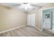 Bright bedroom featuring wood-look floors and double doors to exterior at 91 Mark Twain Ln, Rotonda West, FL 33947