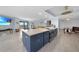 Modern kitchen with blue cabinetry, stainless steel appliances and large island at 25188 Marion Ave # E301, Punta Gorda, FL 33950