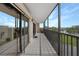 Spacious balcony with water views and sliding glass doors at 25188 Marion Ave # E301, Punta Gorda, FL 33950