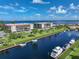 An aerial view of waterfront property with boat slips and a condo building at 25188 Marion Ave # E301, Punta Gorda, FL 33950