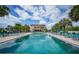 Resort-style pool with lounge chairs and a clubhouse in the background at 25188 Marion Ave # E301, Punta Gorda, FL 33950