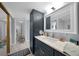 Modern bathroom with vanity, sink, and large mirror at 25188 Marion Ave # E301, Punta Gorda, FL 33950