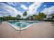 Inviting community pool with lounge chairs and surrounding landscaping at 25188 Marion Ave # E301, Punta Gorda, FL 33950