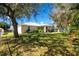 Large backyard with lush grass and mature trees at 4934 Cumbano St, North Port, FL 34287