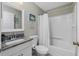 Clean bathroom with granite countertop, white vanity, and tub shower combo at 4934 Cumbano St, North Port, FL 34287