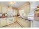 White kitchen with ample cabinetry, microwave, and tile flooring at 641 Colgate Rd, Venice, FL 34293