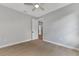 Well-lit bedroom with wood-look tile flooring and ceiling fan at 1411 Liggett Cir, Port Charlotte, FL 33953