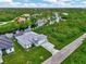 Aerial view of canal-front home with paved driveway at 1411 Liggett Cir, Port Charlotte, FL 33953