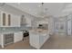 Modern kitchen with white cabinets, marble island, and stainless steel appliances at 1411 Liggett Cir, Port Charlotte, FL 33953