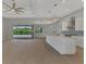 Open kitchen with white cabinets, marble island, and stainless steel appliances at 1411 Liggett Cir, Port Charlotte, FL 33953