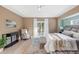 Bright main bedroom with king bed and access to private patio at 91 Mark Twain Ln, Rotonda West, FL 33947