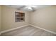 Simple bedroom with light walls and wood-look floors at 91 Mark Twain Ln, Rotonda West, FL 33947