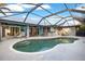 Inviting pool area with covered patio, outdoor bar, and ample seating at 91 Mark Twain Ln, Rotonda West, FL 33947