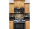 Stainless steel appliances and mosaic backsplash in this updated kitchen at 91 Mark Twain Ln, Rotonda West, FL 33947