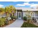 Welcoming front entrance with decorative landscaping and seating area at 91 Mark Twain Ln, Rotonda West, FL 33947
