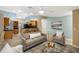 Bright living room with light beige couch and chairs, and a view into the kitchen at 91 Mark Twain Ln, Rotonda West, FL 33947
