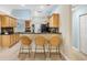 Modern kitchen with light wood cabinets, granite counters, and stainless steel appliances at 91 Mark Twain Ln, Rotonda West, FL 33947