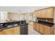 Open concept kitchen with granite counters, stainless steel appliances, and light wood cabinets at 91 Mark Twain Ln, Rotonda West, FL 33947