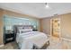 Main bedroom with a king-size bed and en-suite bathroom access at 91 Mark Twain Ln, Rotonda West, FL 33947