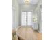 Bright and airy entryway with light wood floors and french doors at 91 Mark Twain Ln, Rotonda West, FL 33947