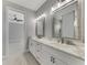 Double vanity bathroom with marble countertop and gray cabinets at 1419 Liggett Cir, Port Charlotte, FL 33953