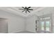 Living room with coffered ceiling, ceiling fan, and entry to the kitchen at 1419 Liggett Cir, Port Charlotte, FL 33953