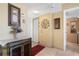 Condo entryway with a cabinet and decorative wall art at 25188 Marion Ave # B304, Punta Gorda, FL 33950