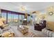 Living room with comfortable seating, a TV, and access to the balcony at 25188 Marion Ave # B304, Punta Gorda, FL 33950