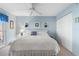 King-size bedroom with light blue walls and ceiling fan at 25188 Marion Ave # B304, Punta Gorda, FL 33950