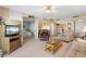 Living room with seating, a TV, and partial bedroom view at 25188 Marion Ave # B304, Punta Gorda, FL 33950