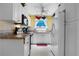 Galley-style kitchen with white cabinets and refrigerator at 25188 Marion Ave # B304, Punta Gorda, FL 33950